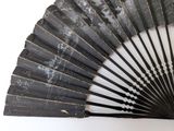 a black fan that is sitting on a white surface