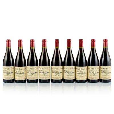 six bottles of red wine lined up in a row