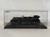 a black model of a car in a clear case