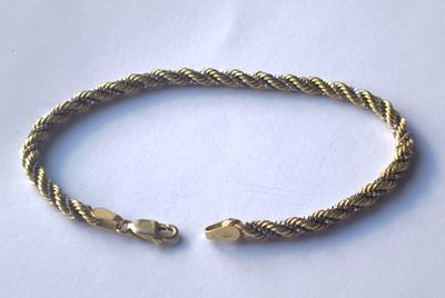 a close up of a bracelet on a white surface