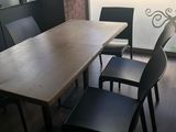 a table and chairs in a room with a large window