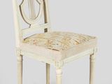 a white chair with a wooden back and a wooden seat