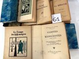 several old books are stacked on top of each other on a table