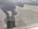a reflection of a person on the windshield of a car