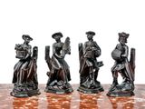 four figurines of people sitting on a chess board