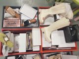 a red box filled with assorted shoes and accessories
