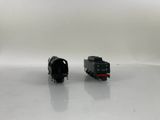 two toy trains sitting side by side on a white surface