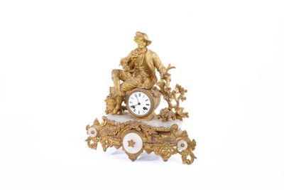 a gold clock sitting on top of a white table