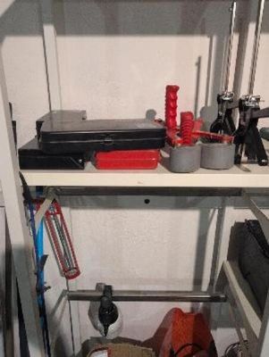 a shelf that has a bunch of tools on it