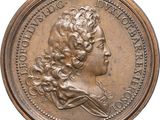 gros plan d'une pièce de monnaie sur laquelle figure un visage de femme