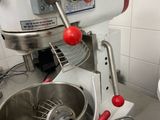 a mixer that is sitting in a kitchen next to a bowl
