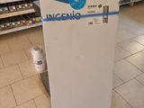 a white refrigerator in a store with a blue and white sign on it