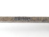 a close up of a metal object on a white surface