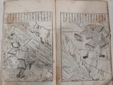 two old books with drawings on them on a table