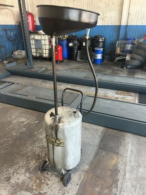 a gas can sitting on top of a cart in a garage