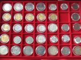a red box filled with lots of different types of coins