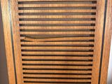 a close up of a wooden cabinet with a door open
