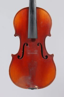 an old violin with a bow hanging from it ' s back