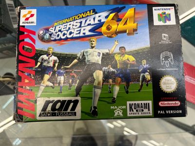 someone is holding a video game in front of a glass case