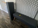 a black bench and a black chair in a room