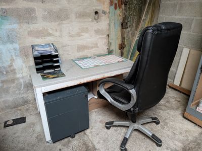 a desk with a chair and a computer on it