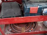 an image of a red work bench with tools on it