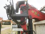 a red machine that is sitting in the back of a truck