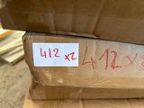 a cardboard box with a sticker on it sitting on top of a cardboard box