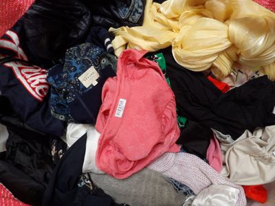 a pile of clothes that is sitting on the floor