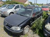 cars are parked in a lot with weeds and weeds in front of them