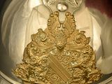 a silver helmet with a gold emblem on it