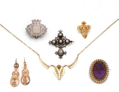 an assortment of jewelry including a necklace, earrings, and a broochle