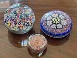 three glass bowls sitting on a table next to each other