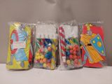 several bags of candy are lined up on a table