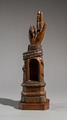 statue of a hand with a rope wrapped around it