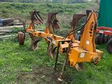 a tractor and a plow in the grass