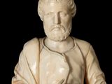 marble statue of a man with a beard and a robe holding a book