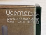 a glass sign that says oceaner on the side of a building