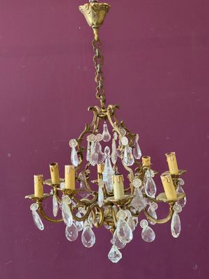 an old chandelier hanging from the ceiling in a purple room