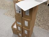 des cartons empilés les uns sur les autres par terre, devant une porte