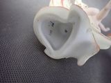 porcelain figurine of an elephant with a heart shaped body sitting on a table