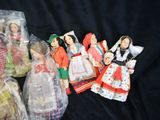 many dolls in plastic bags on a black surface
