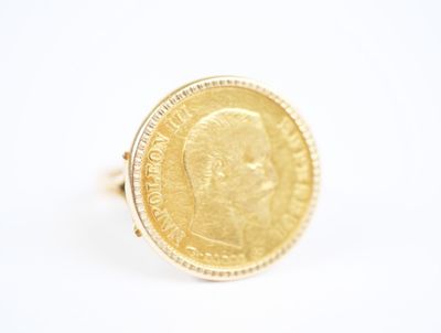 an image of a gold coin ring with a woman ' s face on it