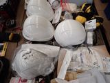 many different types of hard hats and other items on the table