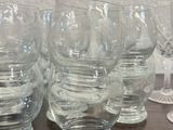 six empty wine glasses sitting on a table next to each other
