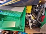 a pile of assorted legos and other toys in a box