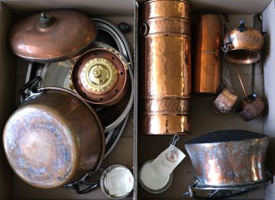 a box full of old copper pots and pans