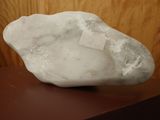 a white rock sitting on top of a wooden table