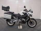 a white and black motorcycle parked in a garage