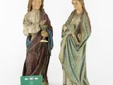 two figurines of jesus and mary with a green box